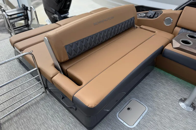 Slide: The Image of 2026 Bennington 30 QXSBAX2 boat interior with tan seating and cup holders. - 24