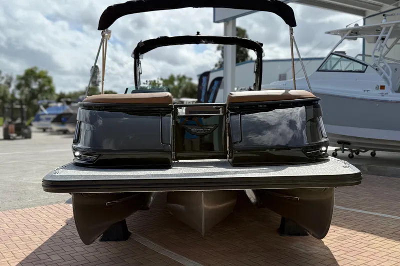 Slide: The Image of 2026 Bennington 30 QXSBAX2 pontoon boat, sleek design, parked outdoors. - 5