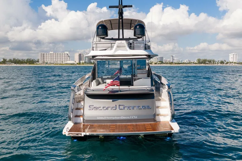Slide: The Image of 2024 Azimut S7 yacht "Second Chances" on water, city skyline in background. - 11