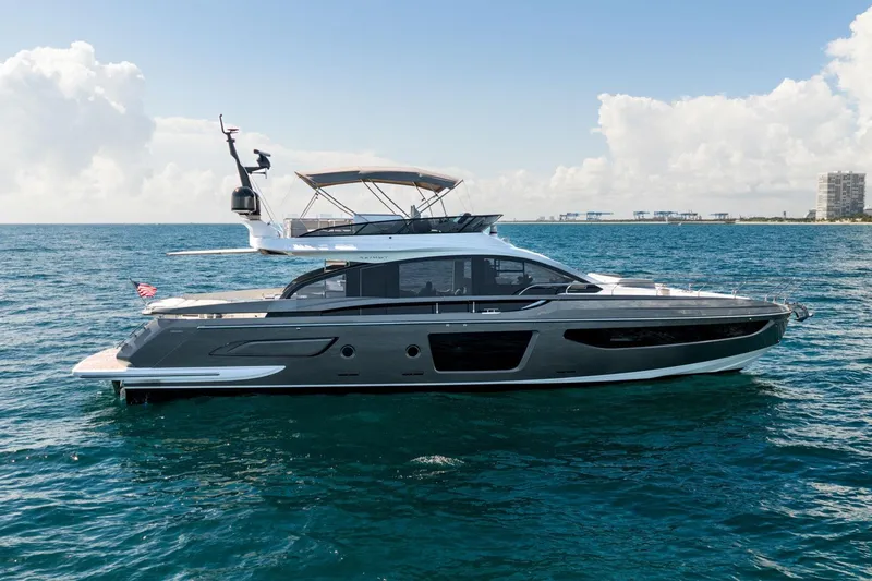 Slide: The Image of 2024 Azimut S7 yacht cruising on open water under a clear blue sky. - 12