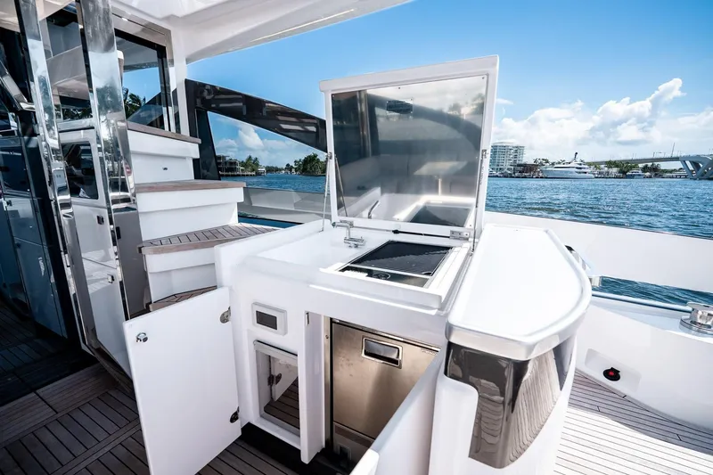 Slide: The Image of Outdoor kitchen on 2024 Azimut S7 yacht with grill and storage, overlooking serene waters. - 19