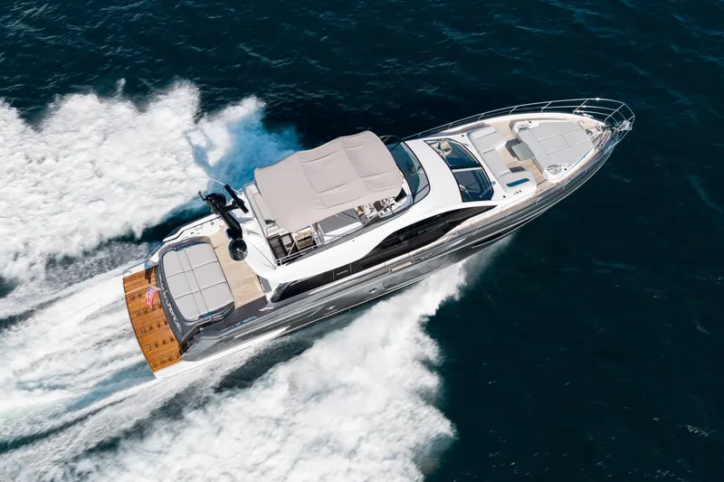 Slide: The Image of 2024 Azimut S7 yacht cruising on open water, aerial view. - 2