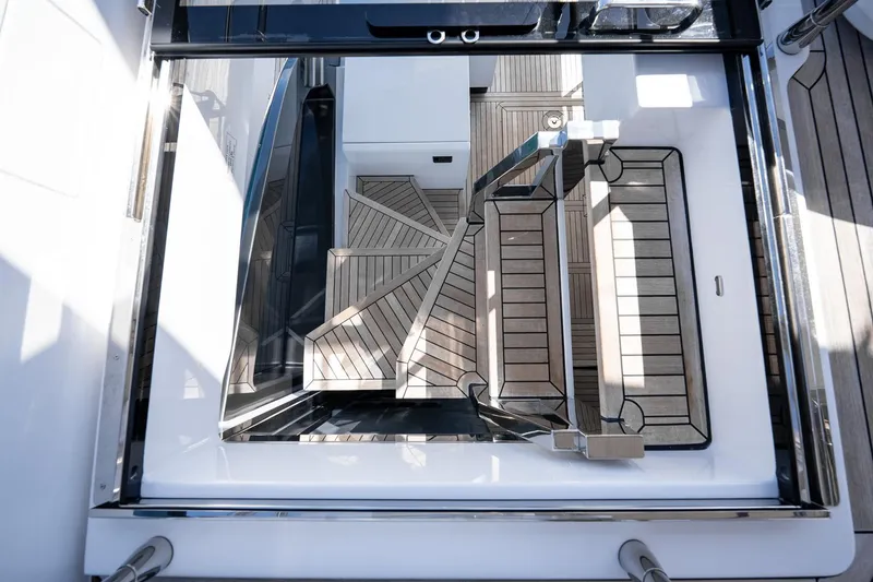 Slide: The Image of 2024 Azimut S7 yacht interior with sleek wooden staircase and modern design elements. - 22