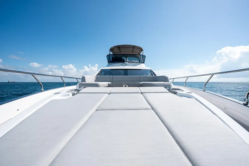 Slide: The Image of 2024 Azimut S7 yacht with spacious sun deck on open sea under clear blue sky. - 33