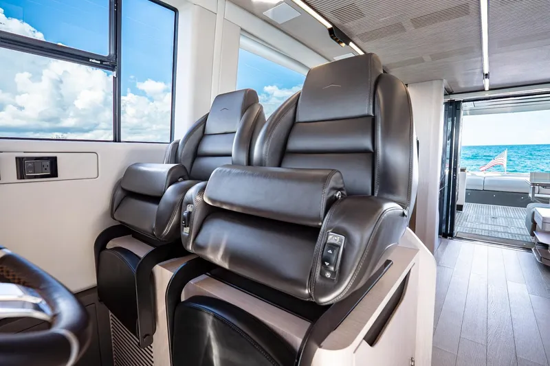 Slide: The Image of Luxurious interior of 2024 Azimut S7 yacht with plush leather seating and ocean view. - 38