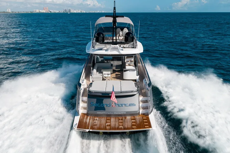 Slide: The Image of 2024 Azimut S7 yacht cruising on open sea, rear view with city skyline. - 4