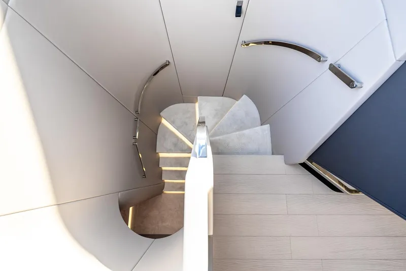 Slide: The Image of Modern spiral staircase inside 2024 Azimut S7 yacht, featuring sleek design and elegant handrails. - 41