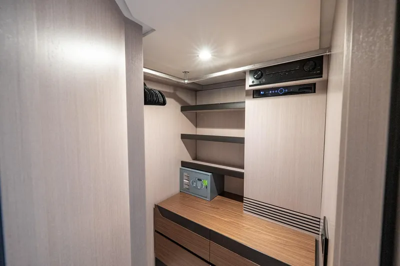 Slide: The Image of 2024 Azimut S7 yacht interior closet with shelves, safe, and audio system. - 47