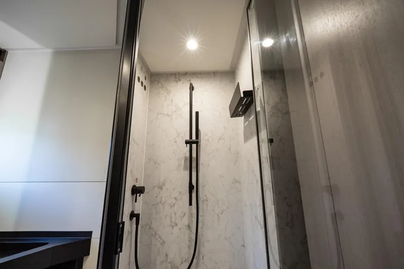 Slide: The Image of Luxurious 2024 Azimut S7 yacht bathroom with modern shower design and elegant marble walls. - 51