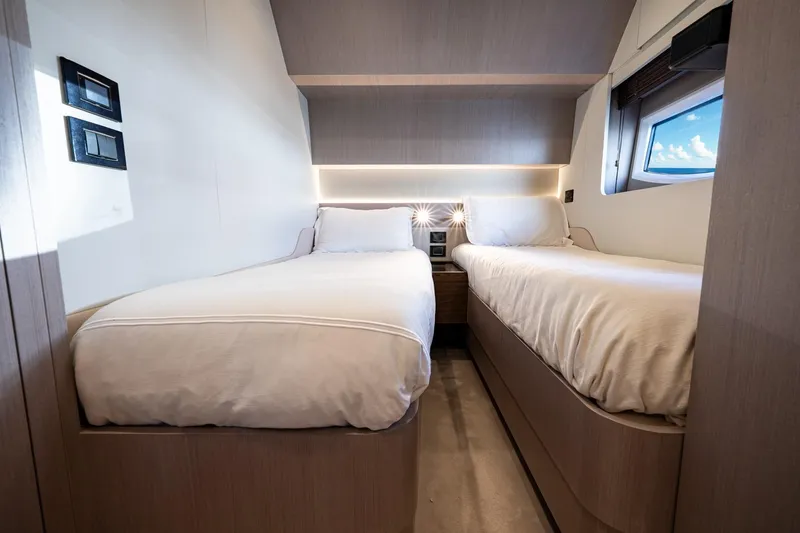Slide: The Image of 2024 Azimut S7 yacht cabin with twin beds and modern interior design. - 52