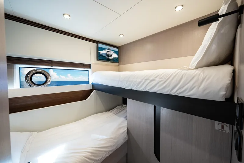Slide: The Image of 2024 Azimut S7 yacht interior with modern bunk beds and ocean view. - 54