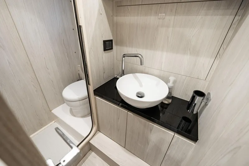Slide: The Image of Luxurious bathroom in 2024 Azimut S7 yacht with modern sink and toilet. - 59