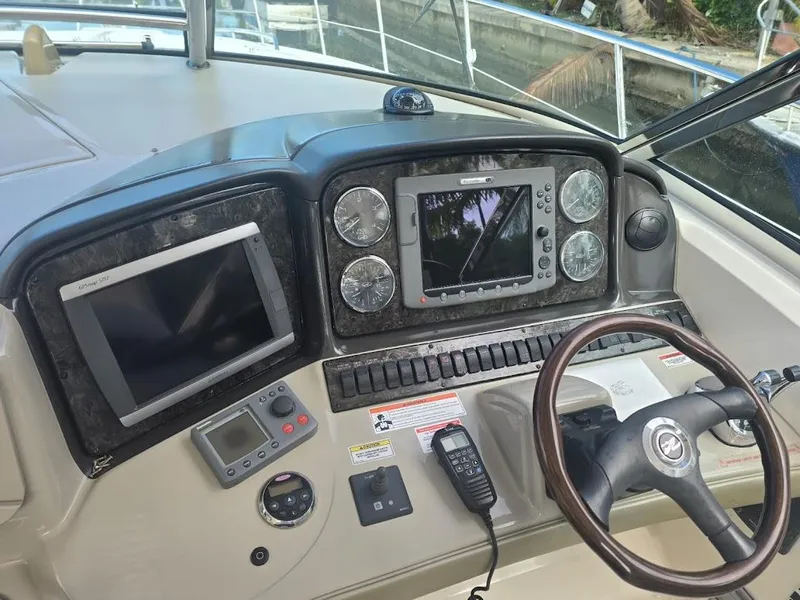 Slide: The Image of Dashboard of a 2008 Sea Ray 40 Sundancer with navigation equipment and steering wheel. - 10