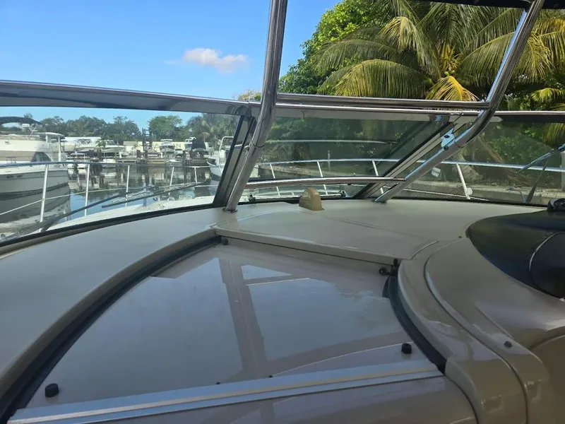 Slide: The Image of 2008 Sea Ray 40 Sundancer yacht interior with marina and palm trees in background. - 12