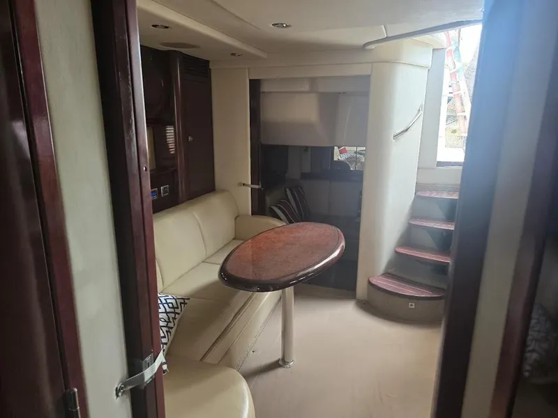 Slide: The Image of Interior of 2008 Sea Ray 40 Sundancer yacht with elegant seating and wooden table. - 13