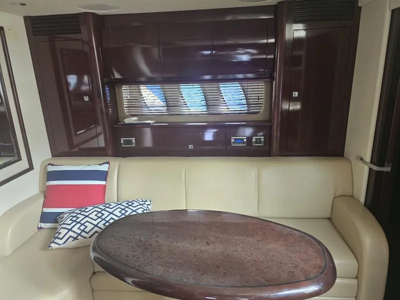 Slide: The Image of Interior of 2008 Sea Ray 40 Sundancer yacht with leather seating and wooden table. - 17
