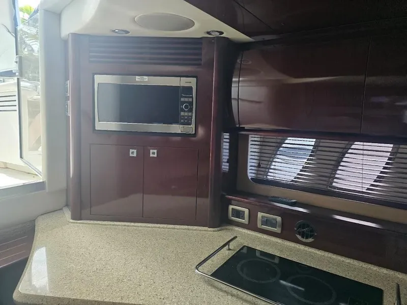Slide: The Image of Interior of 2008 Sea Ray 40 Sundancer yacht kitchen with microwave and stovetop. - 18