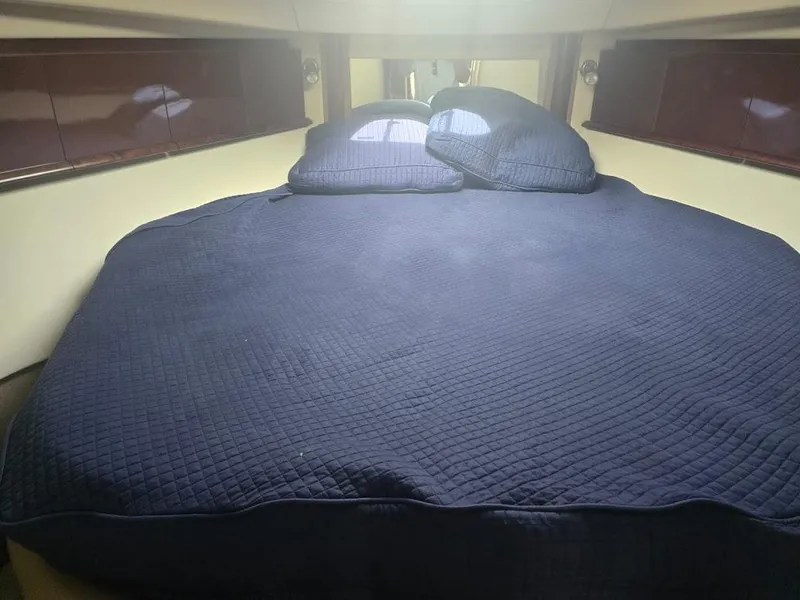 Slide: The Image of Interior cabin of 2008 Sea Ray 40 Sundancer with blue bedding. - 19