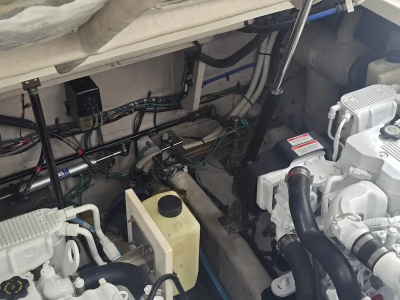 Slide: The Image of Engine compartment of a 2008 Sea Ray 40 Sundancer, showcasing mechanical components and wiring. - 28