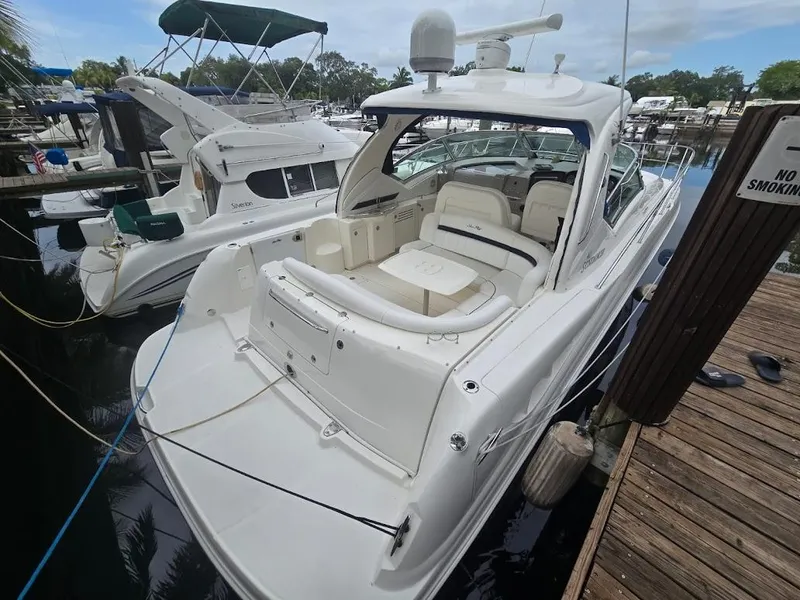 Slide: The Image of 2008 Sea Ray 40 Sundancer yacht docked at marina, showcasing sleek design and spacious deck. - 4