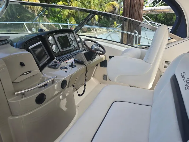 Slide: The Image of 2008 Sea Ray 40 Sundancer cockpit with modern navigation equipment and plush seating. - 9