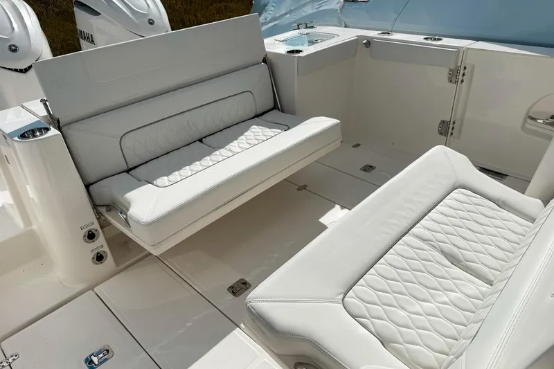 Slide: The Image of 2026 Pursuit S 328 Sport boat interior with white cushioned seating and sleek design. - 10