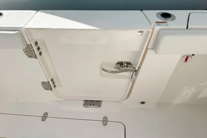 Slide: The Image of 2026 Pursuit S 328 Sport boat door with stainless steel handle and hinges. - 16
