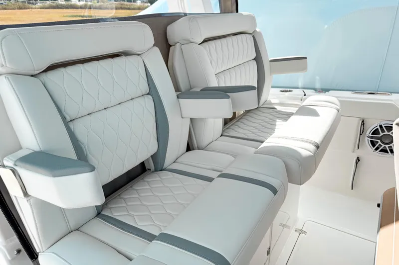 Slide: The Image of Luxurious seating on 2026 Pursuit S 328 Sport boat, featuring elegant white upholstery and armrests. - 18