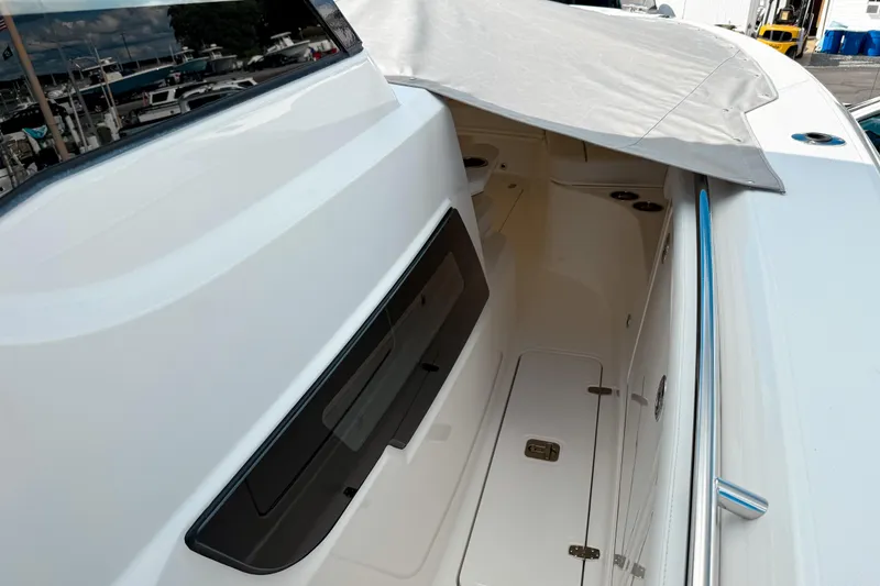 Slide: The Image of 2026 Pursuit S 328 Sport boat interior with sleek design and covered seating area. - 25