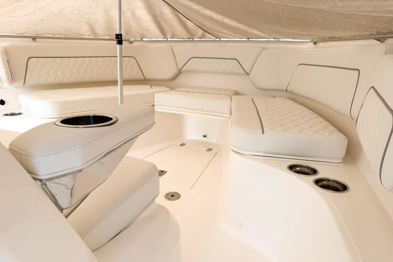 Slide: The Image of Luxurious interior of 2026 Pursuit S 328 Sport boat with plush seating and cup holders. - 27