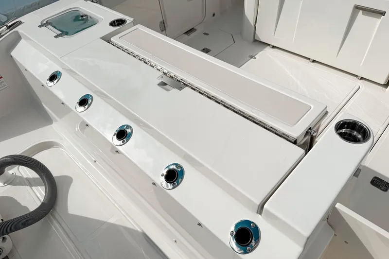 Slide: The Image of 2026 Pursuit S 328 Sport boat interior with rod holders and storage compartments. - 5