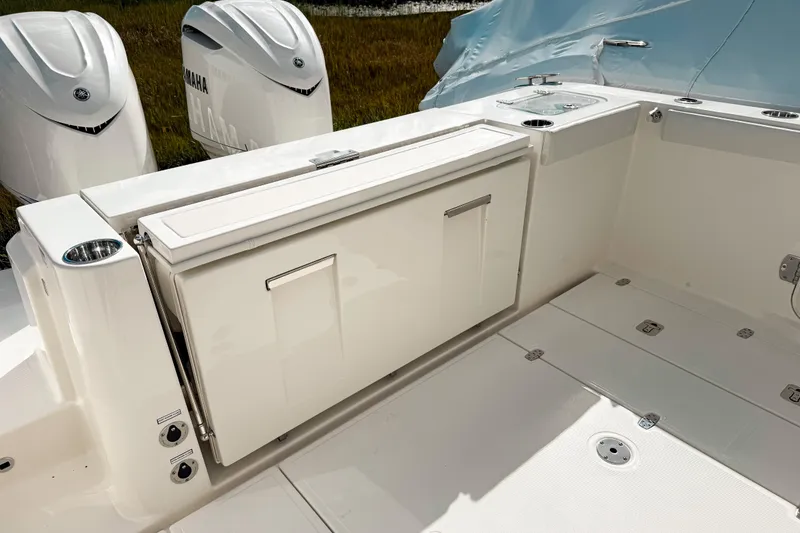 Slide: The Image of 2026 Pursuit S 328 Sport boat deck with Yamaha engines, featuring storage compartments. - 6