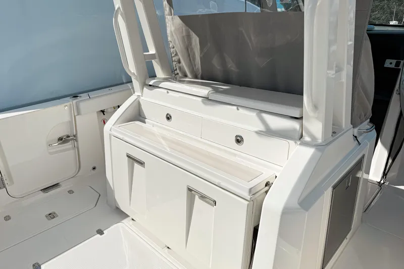 Slide: The Image of 2026 Pursuit S 328 Sport boat interior with sleek white cabinetry and modern design. - 8