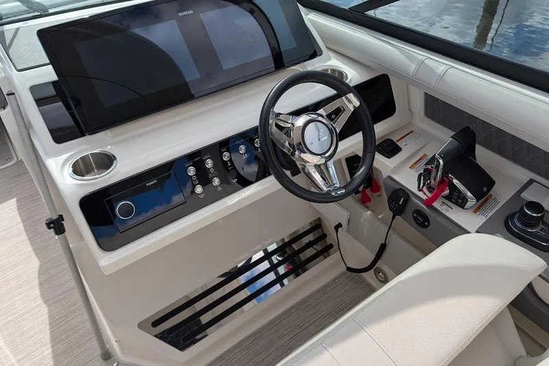 Slide: The Image of 2023 Sea Ray 310 SLX boat interior with sink, mini fridge, and seating area. - 11