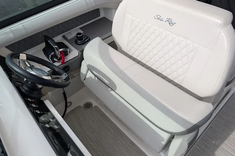 Slide: The Image of 2023 Sea Ray 310 SLX boat dashboard with speaker, controls, and Simrad radio system. - 14