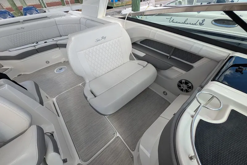 Slide: The Image of 2023 Sea Ray 310 SLX boat cockpit with steering wheel and luxurious seating. - 15