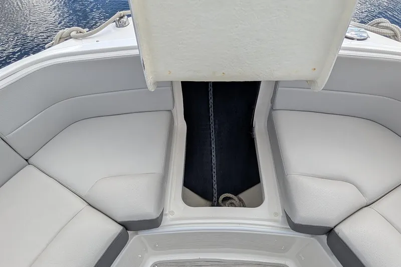 Slide: The Image of Luxurious seating area on 2023 Sea Ray 310 SLX boat, featuring sleek gray upholstery. - 22