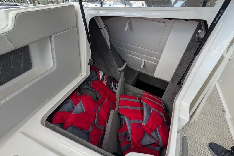 Slide: The Image of 2023 Sea Ray 310 SLX boat interior with open anchor storage compartment. - 23