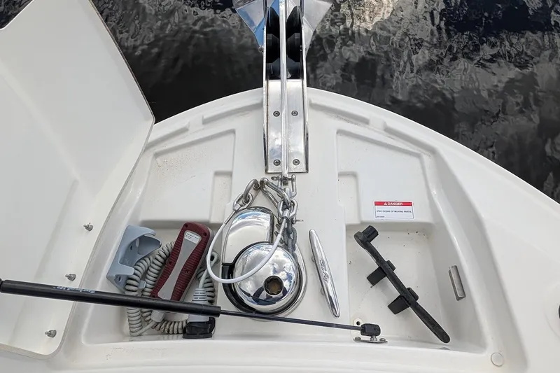 Slide: The Image of Storage compartment with red life jackets on a 2023 Sea Ray 310 SLX boat. - 24