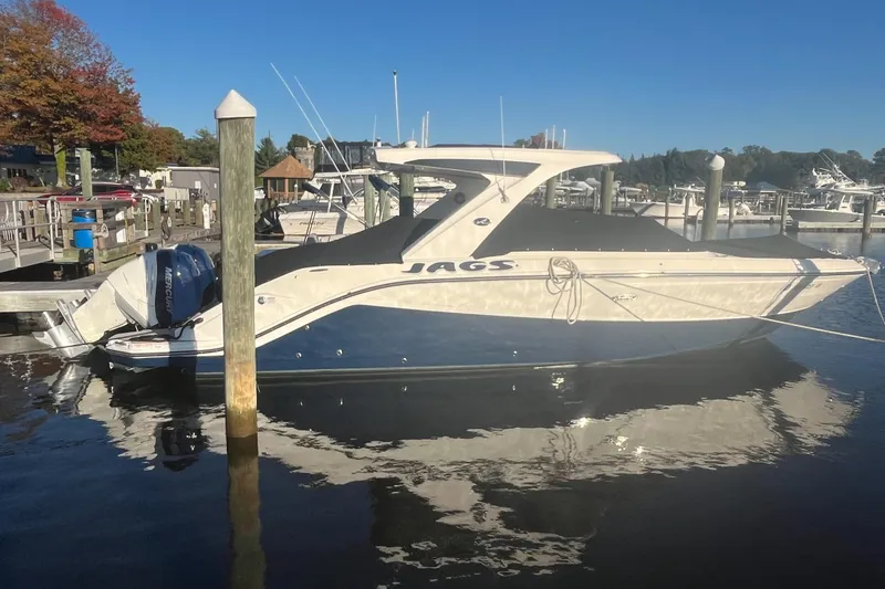 Slide: The Image of 2023 Sea Ray 310 SLX boat docked at marina, covered and secured. - 28