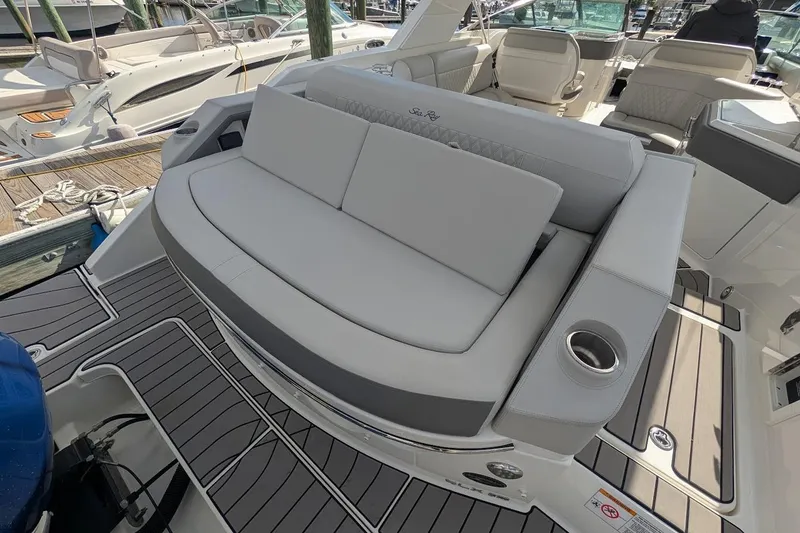 Slide: The Image of 2023 Sea Ray 310 SLX boat with spacious seating and dual Mercury engines. - 4