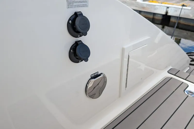 Slide: The Image of 2023 Sea Ray 310 SLX boat interior with Fusion audio system and plush seating. - 6