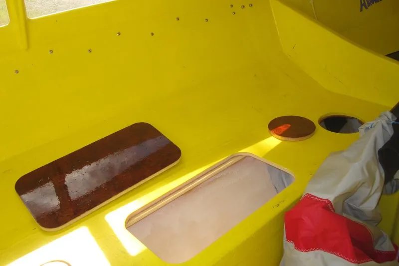 Slide: The Image of Yellow interior of 2007 Scarab 22 boat with storage compartments. - 10