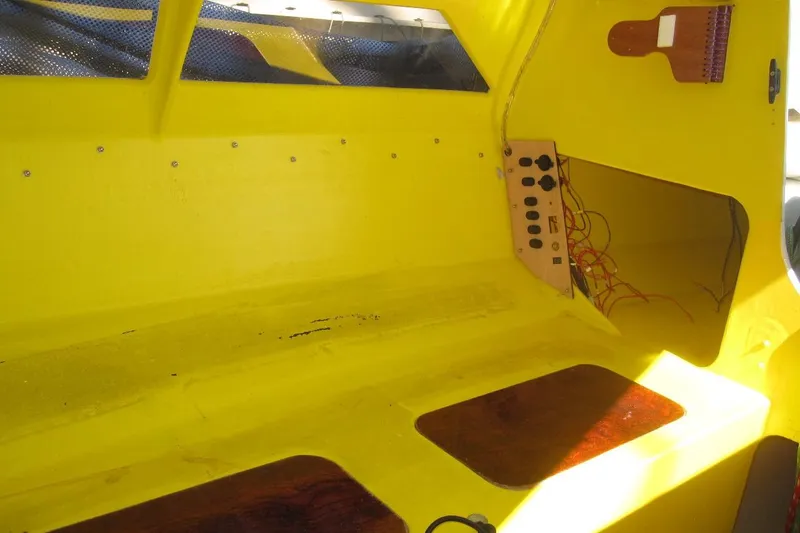 Slide: The Image of Interior of a 2007 Scarab 22 boat, featuring a bright yellow cabin and control panel. - 12