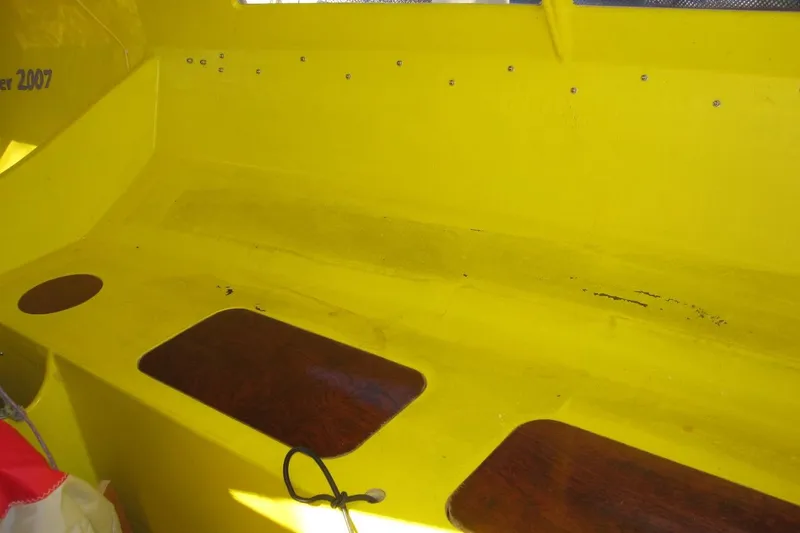 Slide: The Image of Yellow interior of a 2007 Scarab 22 boat with wooden accents. - 13
