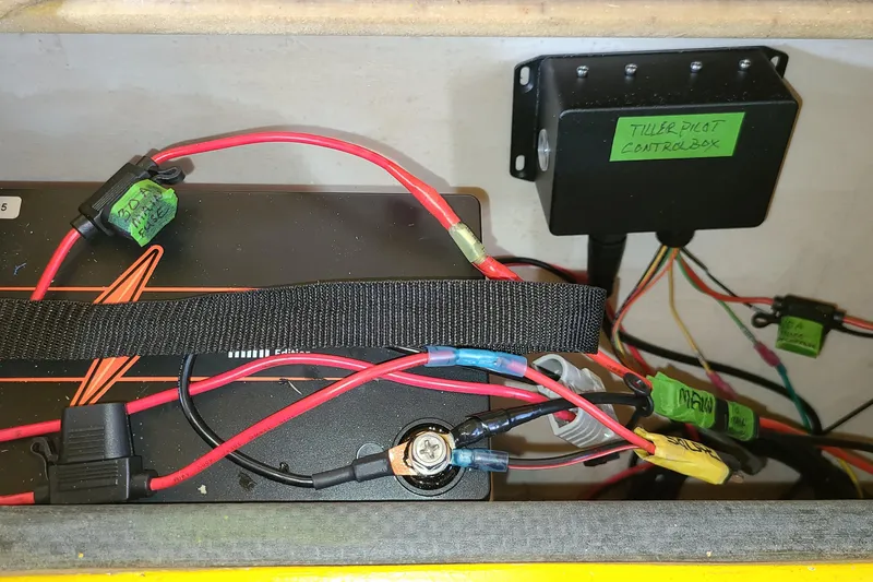 Slide: The Image of Electrical wiring and control box inside a 2007 Scarab 22 boat. - 16