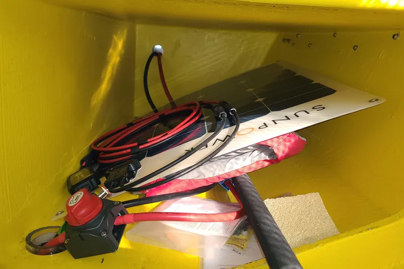 Slide: The Image of Yellow interior of 2007 Scarab 22 with solar panel and wiring components. - 17