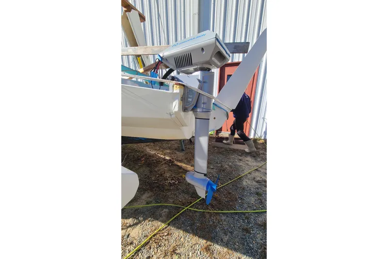 Slide: The Image of 2007 Scarab 22 boat with mounted motor, outdoor setting, person in background. - 18