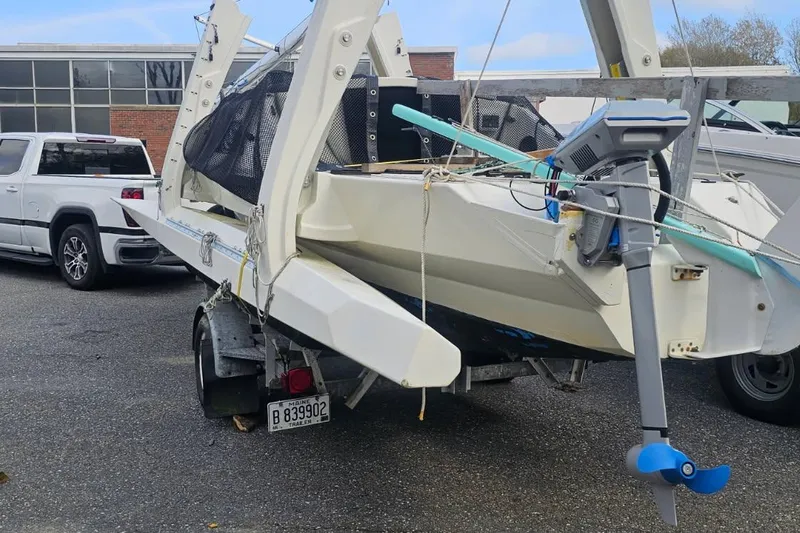 Slide: The Image of 2007 Scarab 22 boat on trailer, parked near a white truck. - 19