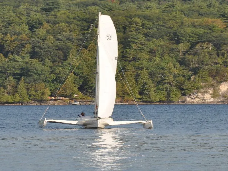 Slide: The Image of Sailboat on a lake with forested shoreline, Scarab 22 model, 2007. - 4